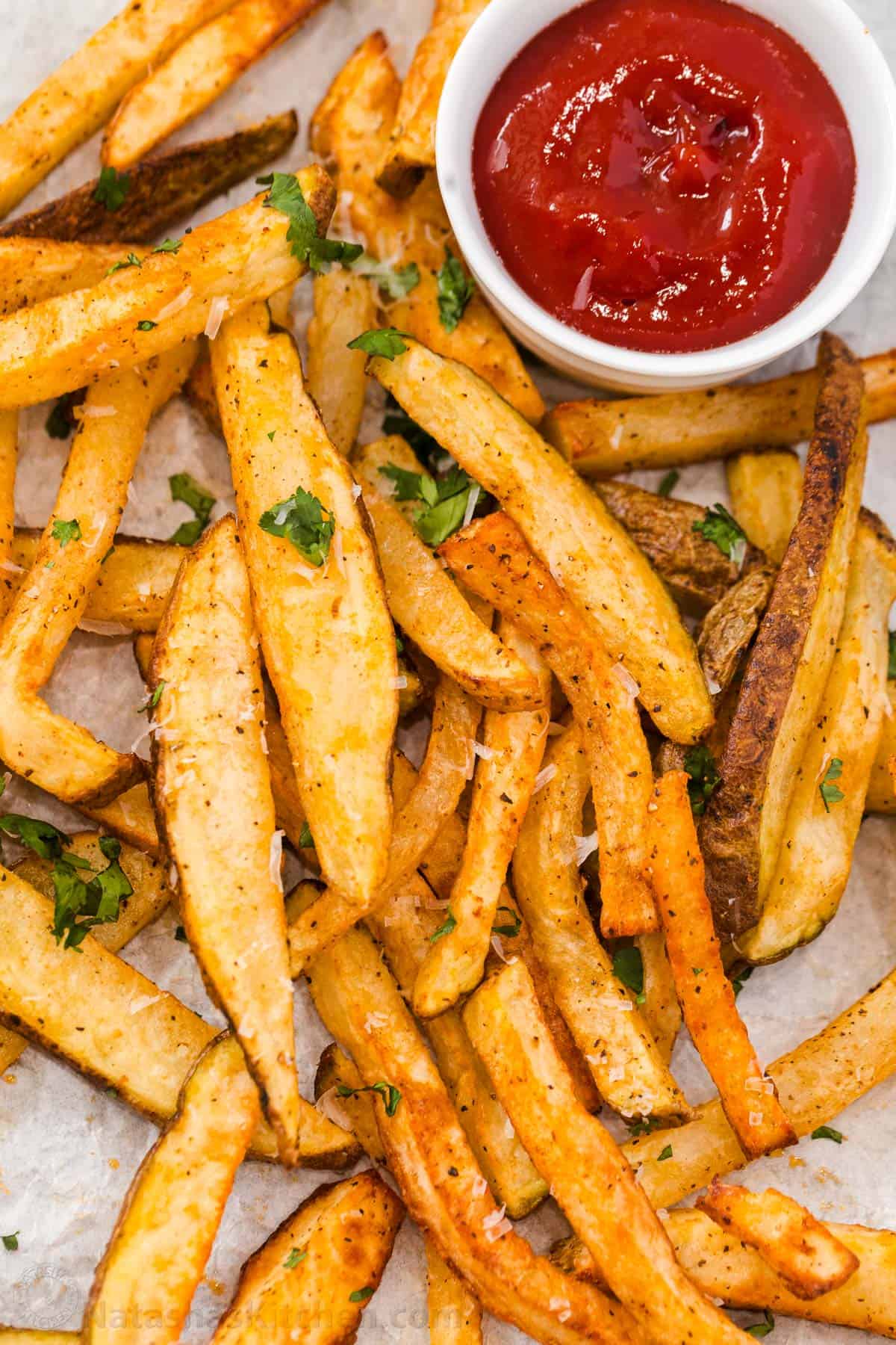 Homemade French Fries in the air fryer on a platter with ketchup on the side