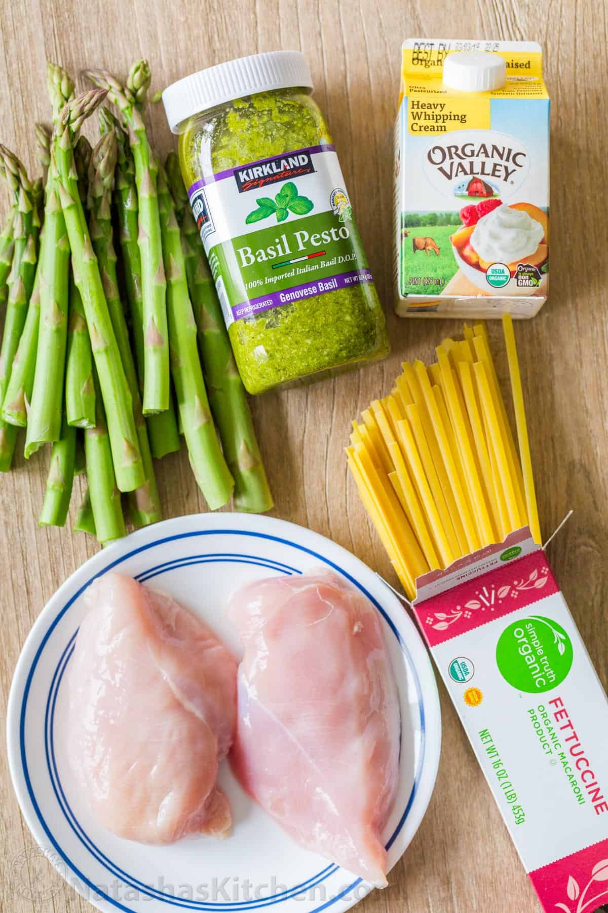 Chicken Pesto Pasta recipe ingredients with basil pesto, asparagus, heavy whipping cream, fettuccine noodles, and chicken breast