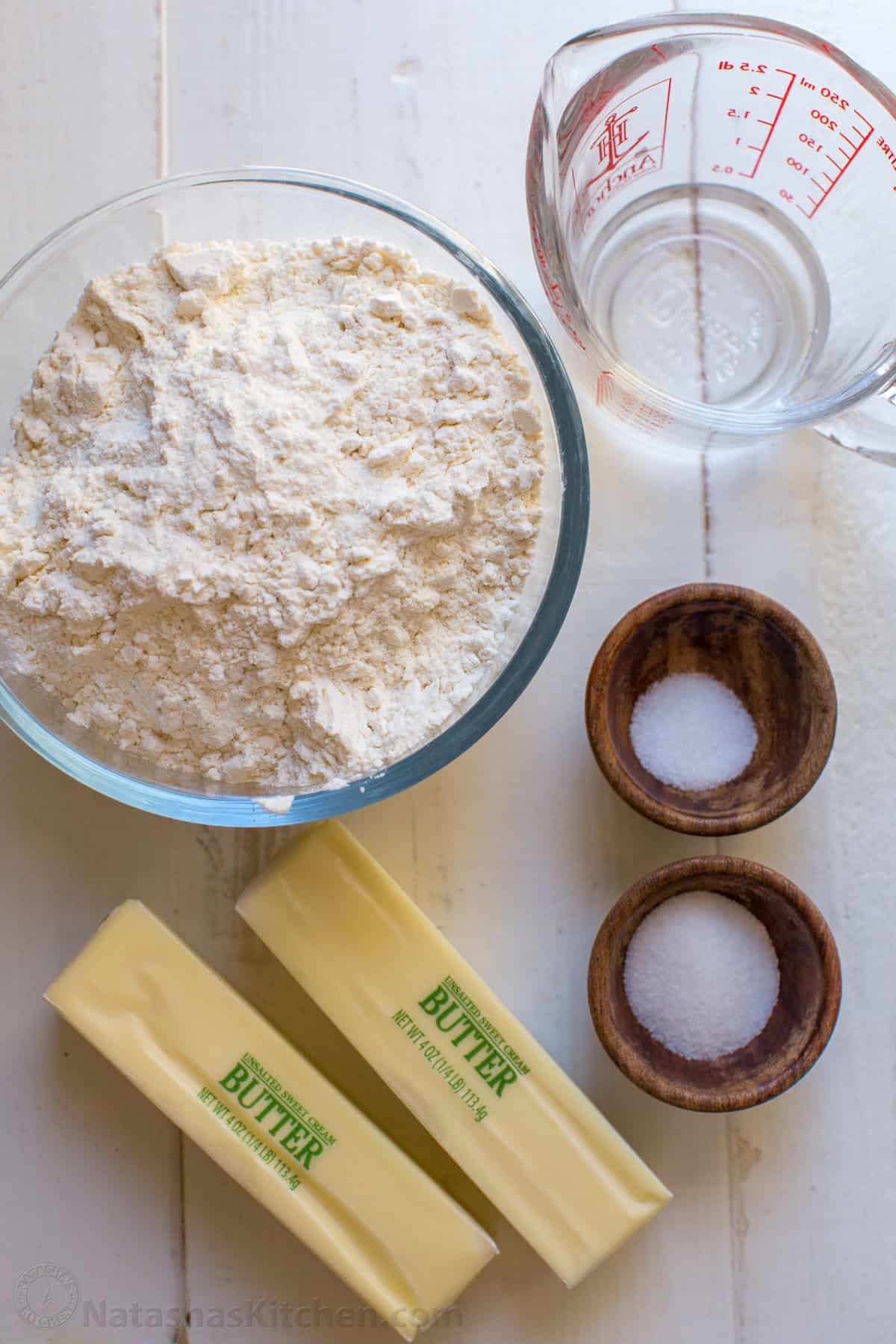 Ingredients for homemade pie crust with flour, water, salt, sugar and butter. 