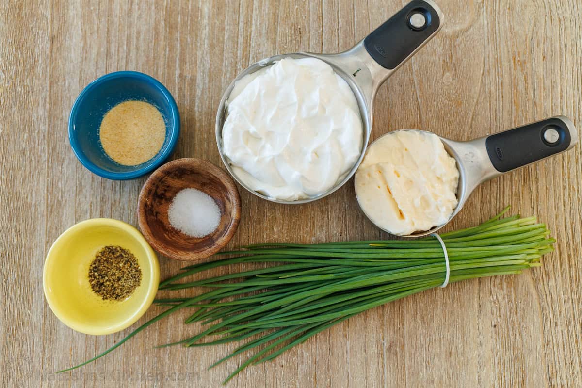 Ingredients for easy homemade ranch dip including sour cream, mayo, chives, salt, pepper and garlic powder