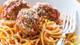 Spaghetti and meatballs served with a fork